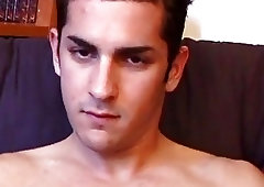 Muscled guy rubs his gay cock and fingers his asshole