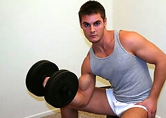 Brenden is jacking off furiously on a bed