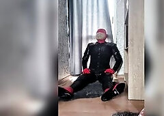 Hubert Kate wearing latex catsuit, latex gloves, corrsets, heels, doing solo breath play in latex mask