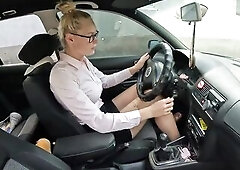 A stylish business woman in a taut petticoat, blouse with unfathomable cleavage and glasses is rushing to work. But when this babe sits in her car, it