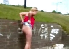 Blonde street girl is showing us her pussy and her tits in the abandoned park
