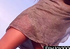 Lovely beauty is having fun on the beach, showing off her shaved pussy and perky tits.