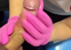 A Sperm Bank Nurse Milks Donated Sperm Into A Cup Wearing Pink Gloves