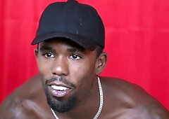 Muscular black man in cap gives handjob commands with dominant presence