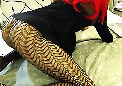 Crossdresser teasing on the bed