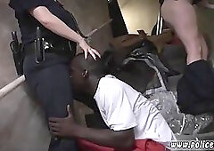 Two naughty police officers are enjoying, while a black prisoner is licking their big asses