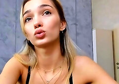 Blonde teen in solo action with her pussy