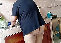 Neighbor Chubby lady in the kitchen of the apartment next door