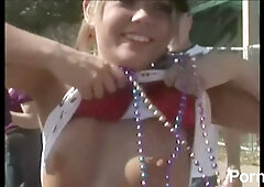 College girls flirt and flash at a wild outdoor party with beads and piercings