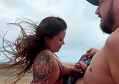 Sucking his cock on the beach for everyone to see.